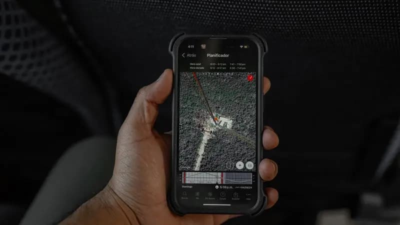 A hand holding a phone showing a map to locate a lost device