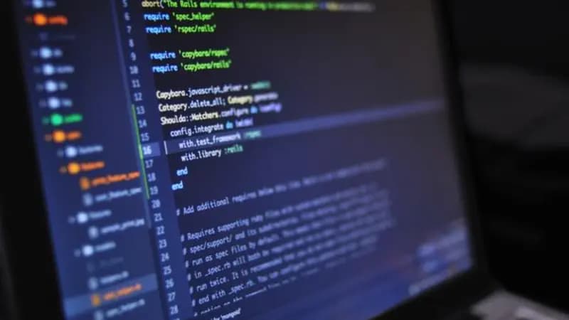 A laptop screen showing lines of code